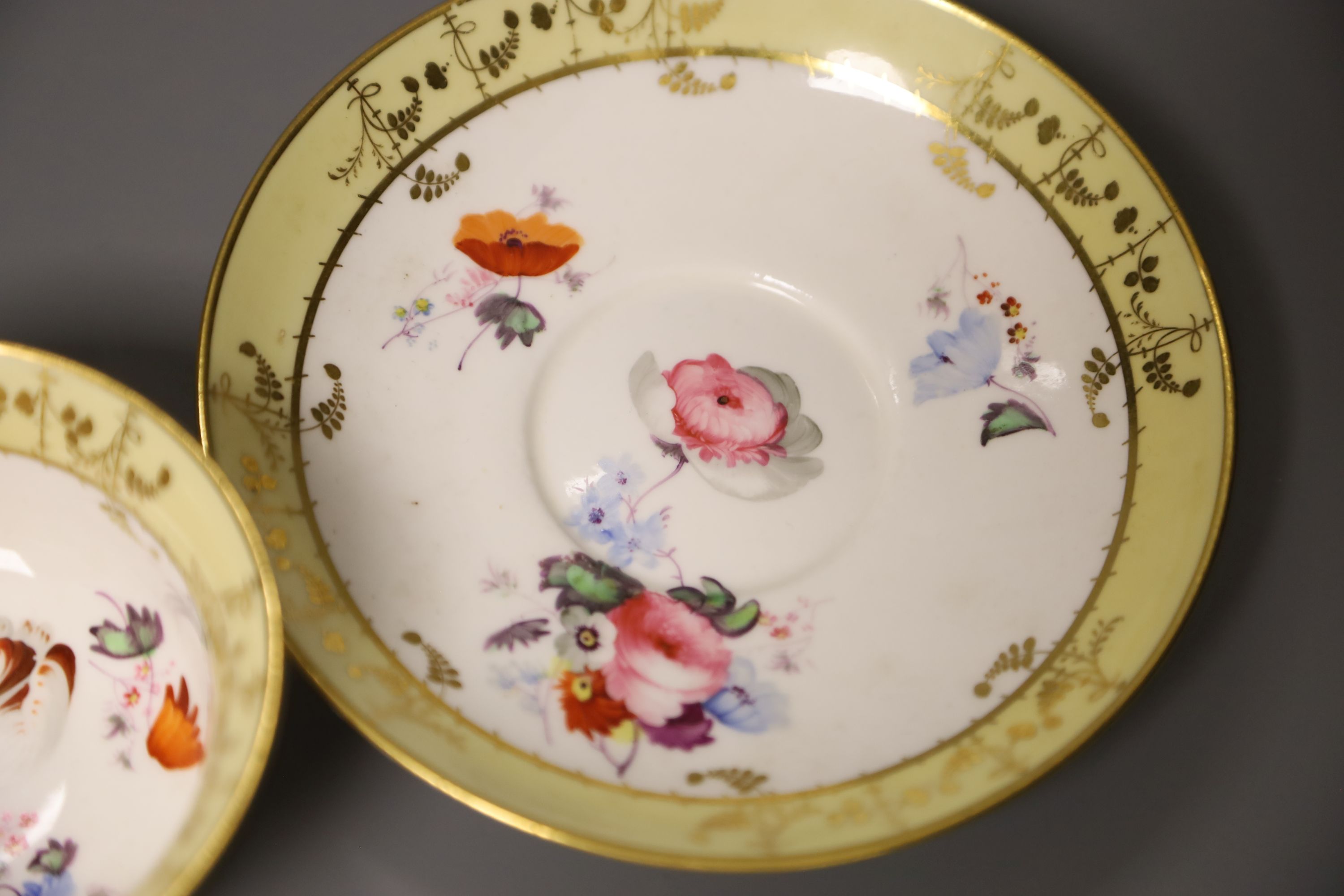 A Worcester Flight Barr teacup and saucer with gadroon border gilded with trailing berries on a salmon ground and Graingers Worcester